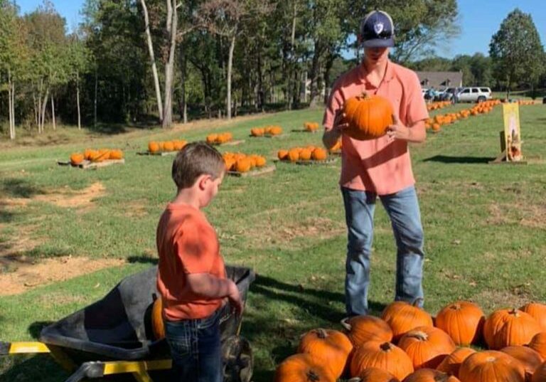 boys holding pumpkins